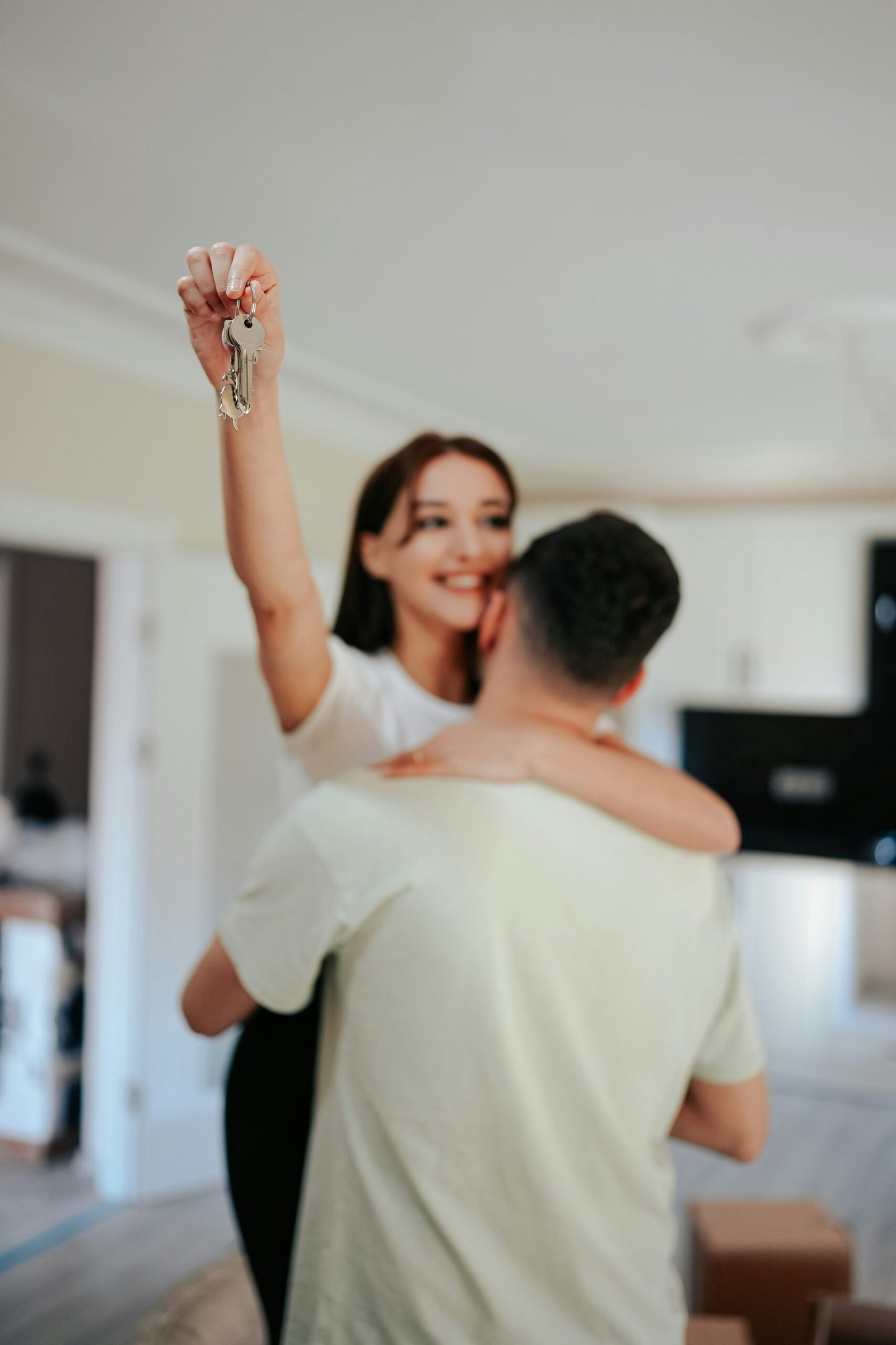 A couple celebrating with the keys to their first home