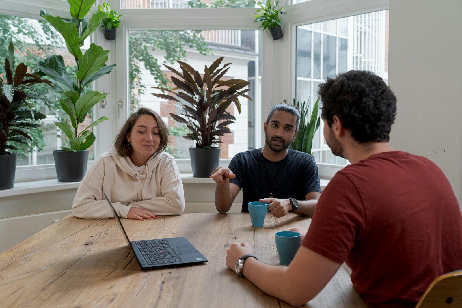 A couple meeting their mortgage adviser at a kitchen table