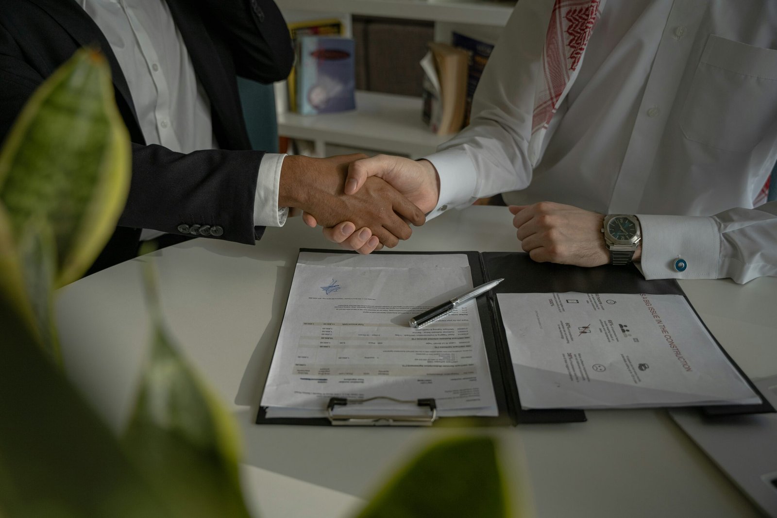 Shaking hands over a signed mortgage agreement